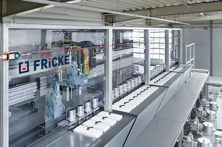 Industrial dosing and filling system from FRICKE in a production environment.
