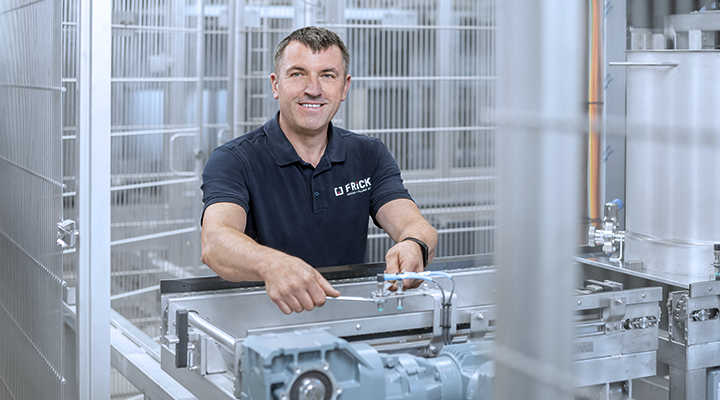 The technician smiles contentedly as he works on a complex dosing system to ensure efficiency.